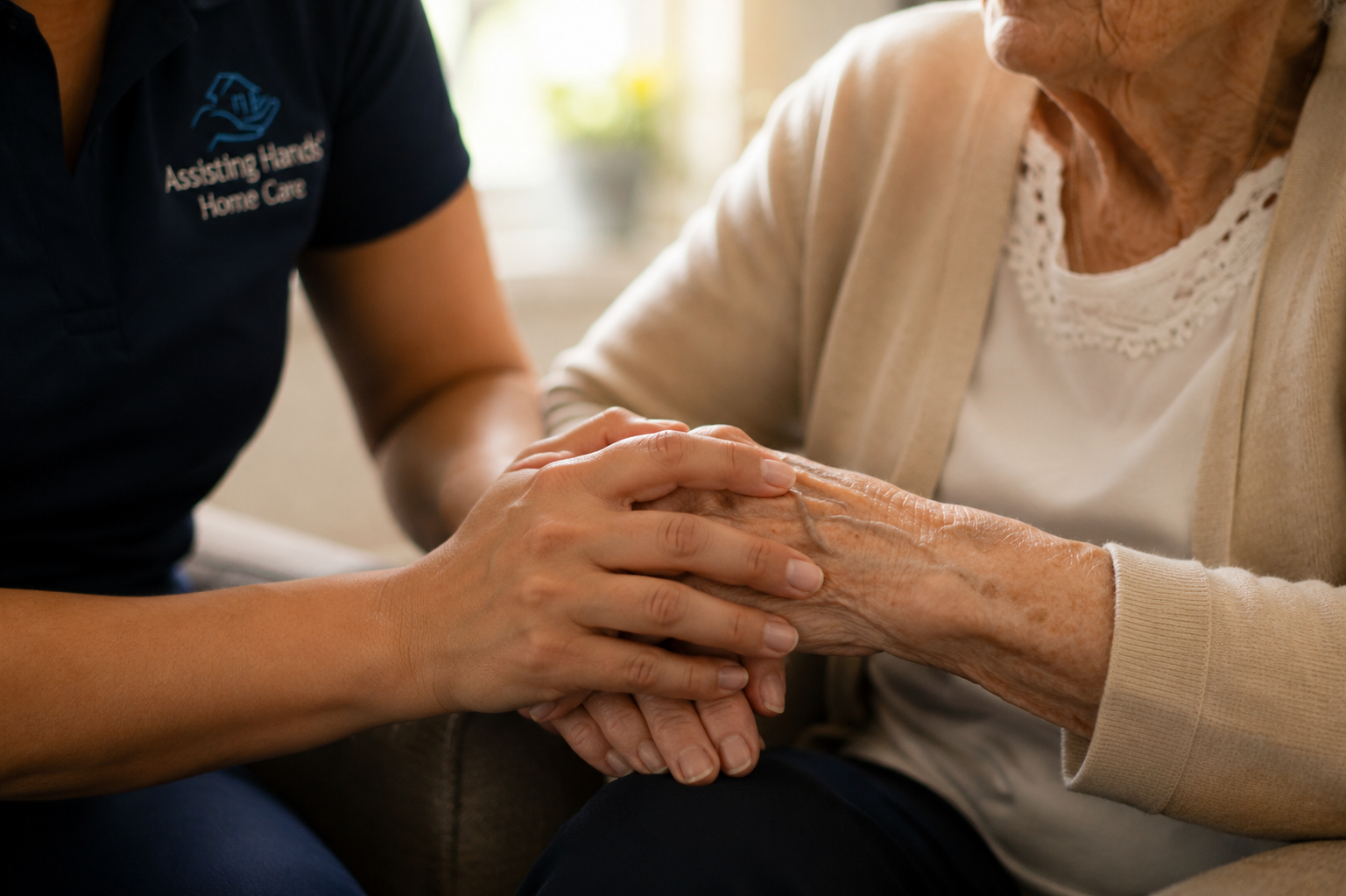 Care delivered with compassion, dignity, and respect Caregiver holding hands with a senior woman during a quiet conversation at home